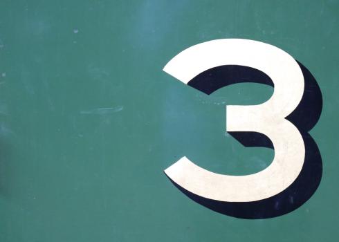The number 3 on a green background. 